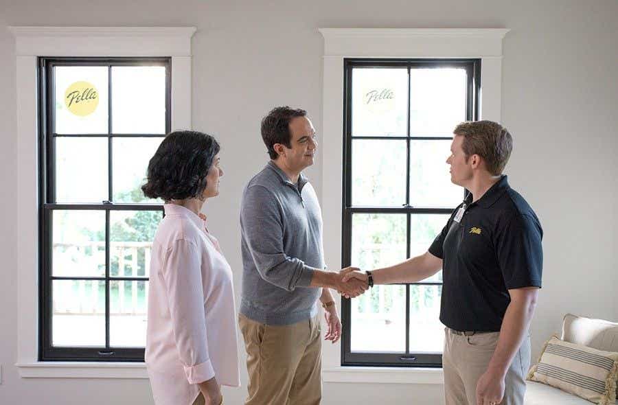 Pella Consultant shaking hands with couple