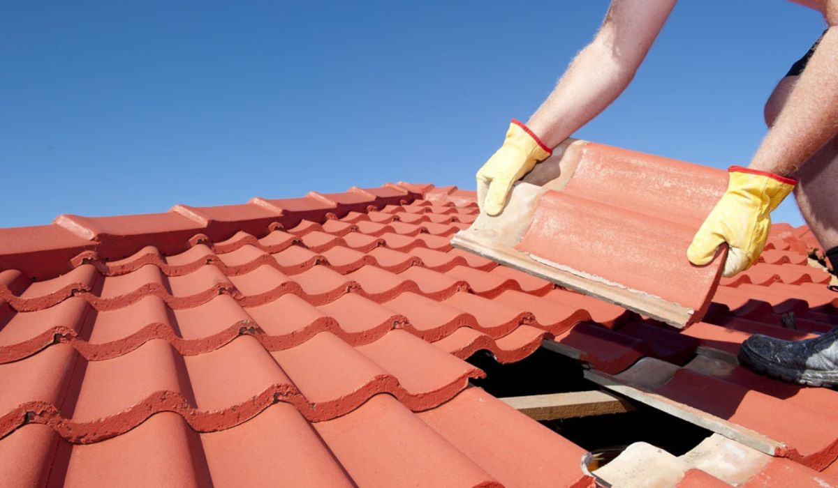 a roofer installing roof tiles