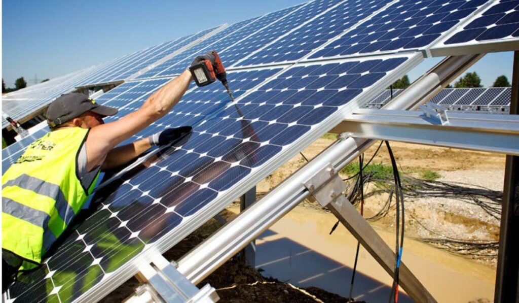 a roofer professional installing a solar panel on a roof