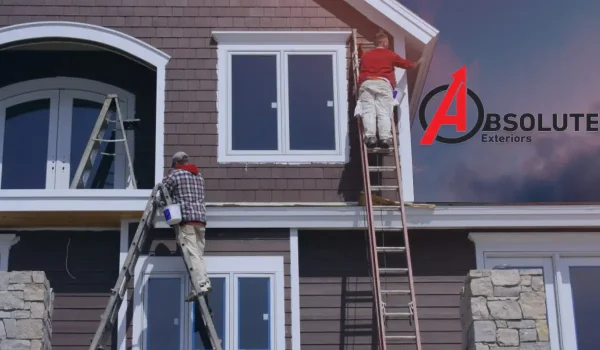 Two men are replacing the siding of a two story house. | Contact your nearest Exterior design consultation